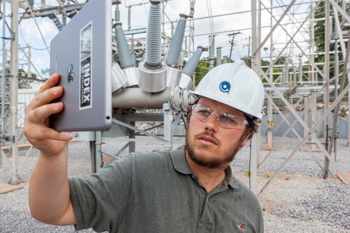 Index team member holding tablet in substation