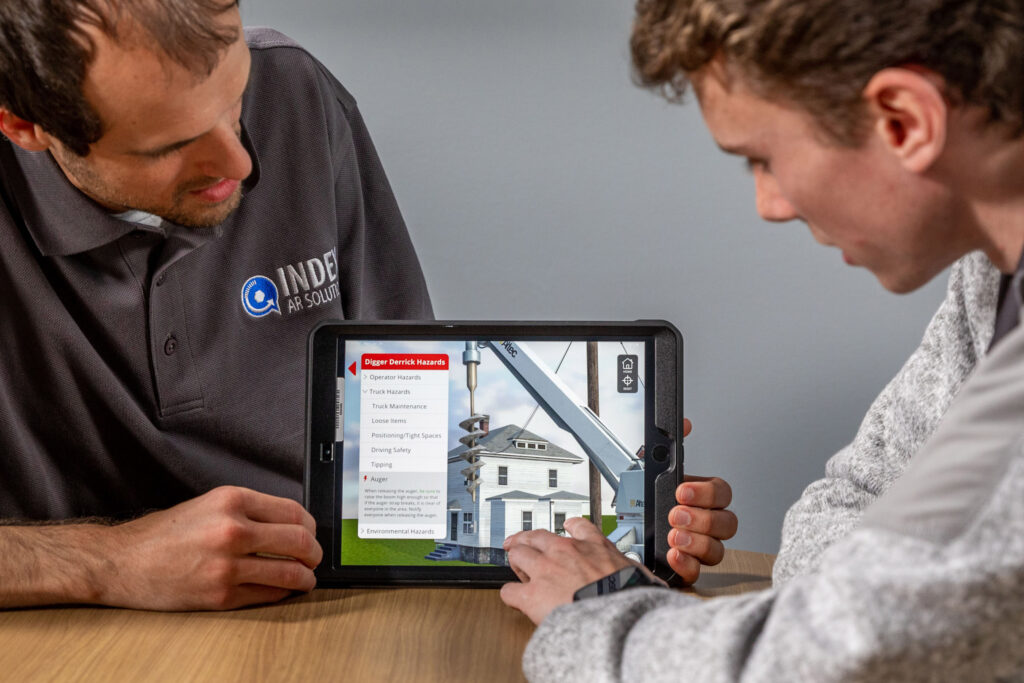 Two students interacting with tablet